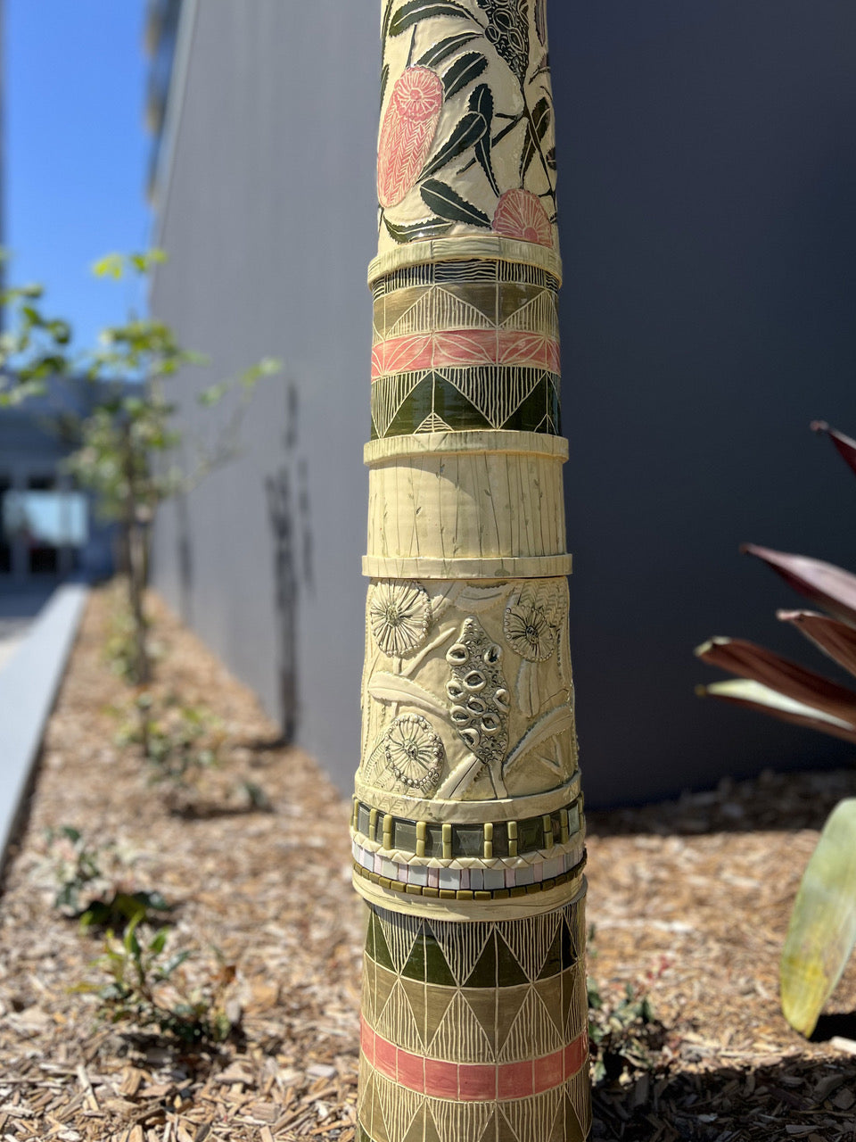 Detail image showing texture work in a all ceramic sculpture with pink banksia flowers and mosaic inlay