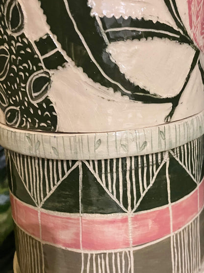 Marking details on a tall ceramic sculpture with pink banksia flowers and mosaic inlay